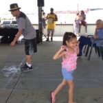 Little girl joins small group of dancers at Reggae on West Beach in New Bedford