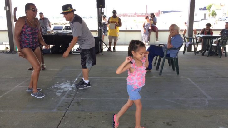Little girl joins small group of dancers at Reggae on West Beach in New Bedford