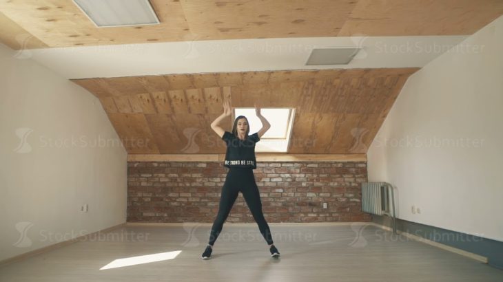 beautiful athletic girl dancing vogue and jumping long shot