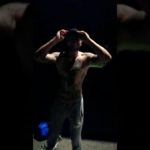 Bodybuilder Flexing late at night